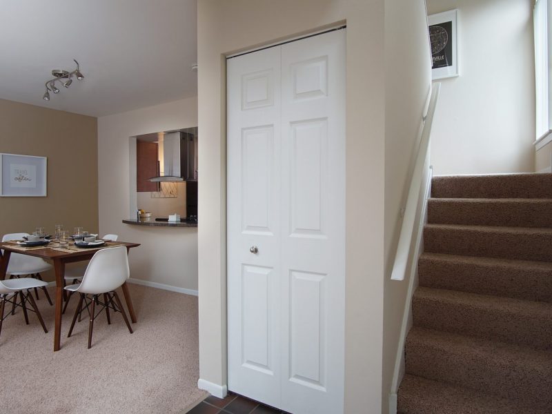 This image shows the dining area starring a stairway up to the bedroom area.