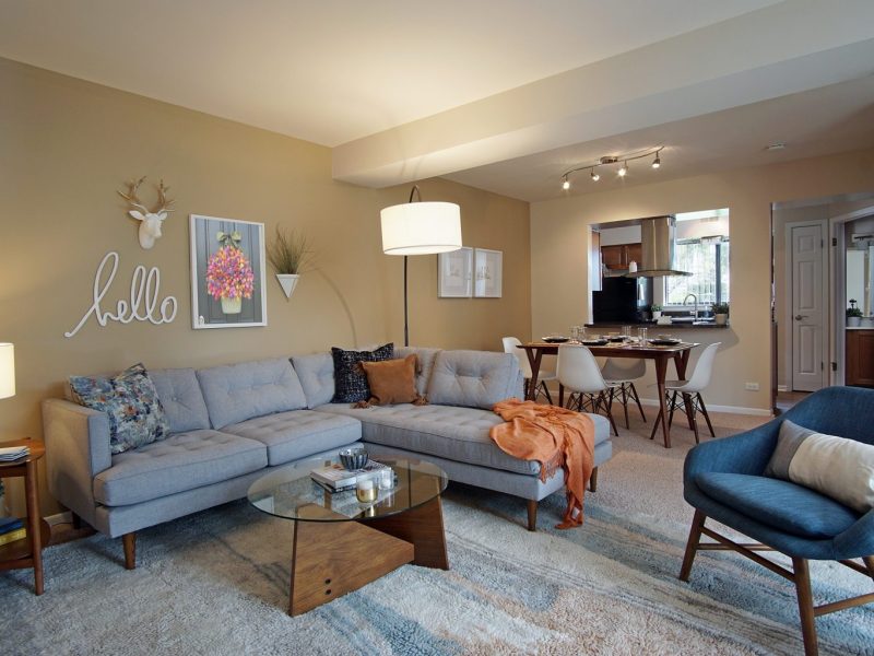 This image shows the Premium Apartment Feature, particularly the living room area showcasing its stylish furniture, wall sceneries, and textures. The living room was also directly accessible to the dining room and kitchen island.