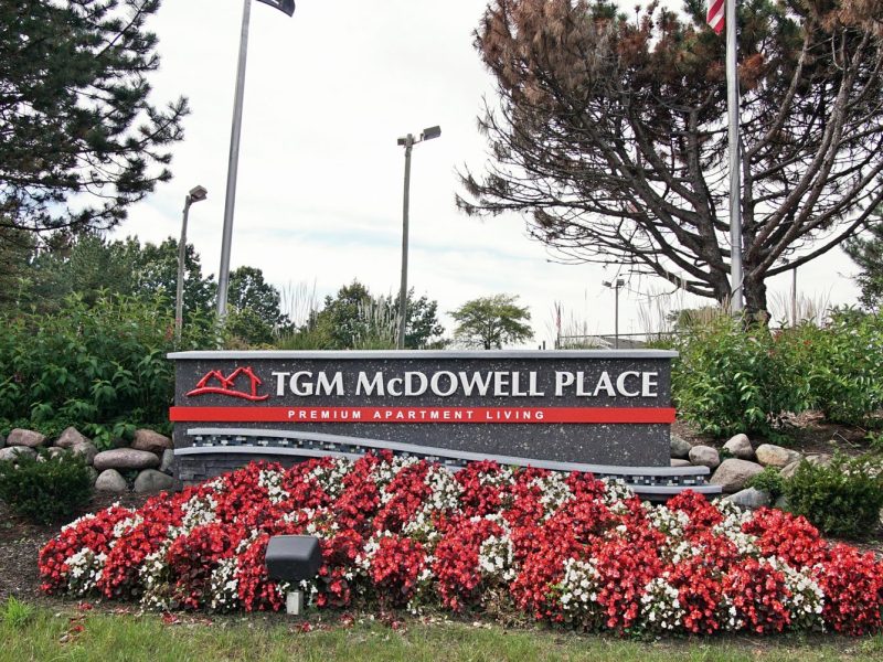 This image shows the monument of TGM Mcdowell Place, overviewing the tennis courts.