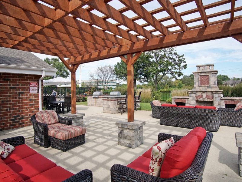 This image shows the outdoor kitchen and lounge with a fireplace.