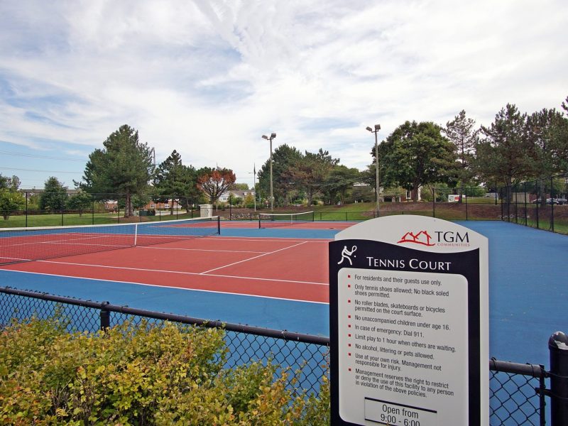 This image shows the spacious tennis court with safety measures rule.